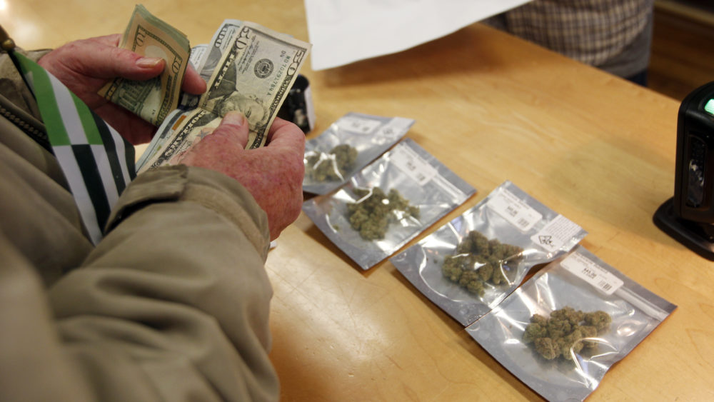 A customer buys marijuana at Harborside dispensary in Oakland, Calif., on Monday.