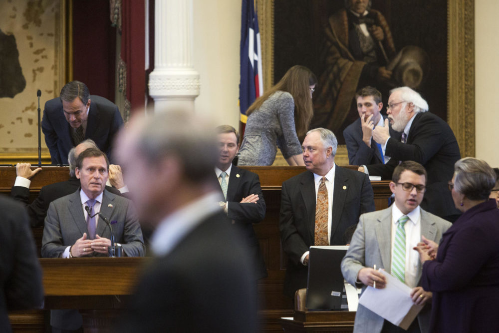Texas House representatives confer in March during the 85th legislative session.
