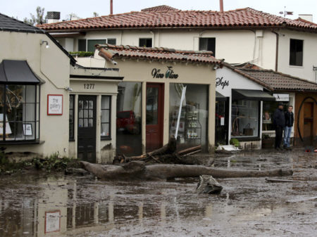Debris and mud cover the street in front of shops in Montecito, Calif., Tuesday after heavy rain brought deadly flooding to the region.