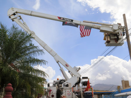 Army reservist Eric Elder, a lineman in civilian life, works with the Corps of Engineers to restore power in the hilly Rio Grande neighborhood east of San Juan.