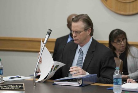 Executive Director Harvey Hildebran gathers his papers to leave the room shortly after being fired by the Texas Facilities Commission board on Jan. 25, 2018.