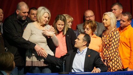 The parents of the deceased 15 year old Bailey Holt, left, stand in tears as Kentucky Gov. Matt Bevin signs the prayer proclamation on Friday, Jan. 26, 2018 in Benton, Ky.