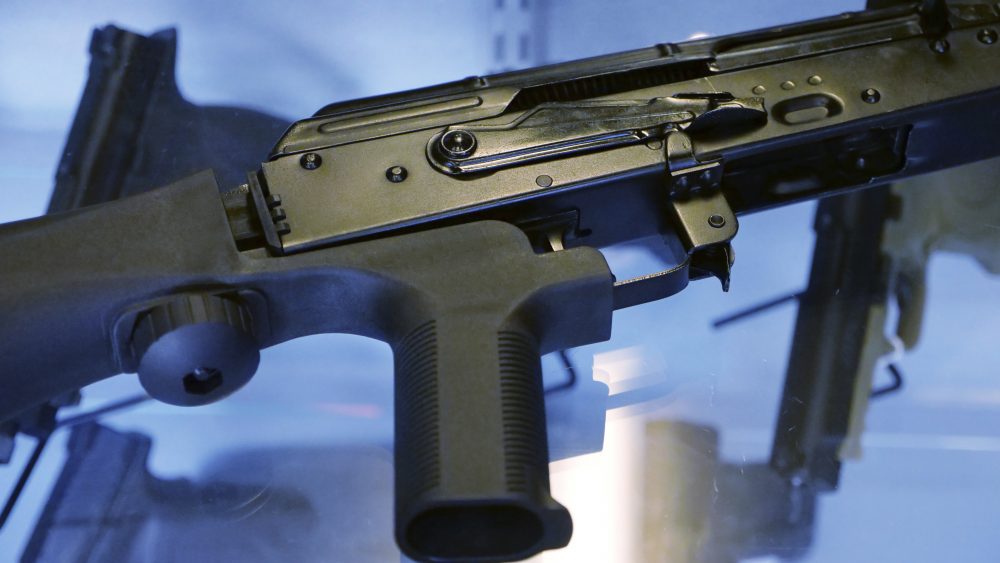 In this Oct. 4, 2017, photo, a device called a "bump stock" is attached to a semi-automatic rifle at the Gun Vault store and shooting range in South Jordan, Utah. The National Rifle Association announced its support Ton Oct. 5 for regulating the devices that can effectively convert semi-automatic rifles into fully automated weapons and that were apparently used in the Las Vegas massacre to lethal effect. It was a surprising shift for the leading gun industry group, which in recent years has resolutely opposed any gun regulations. Immediately afterward the White House, too, said it was open to such a change. (AP Photo/Rick Bowmer)