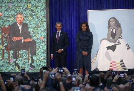 Former President Barack Obama and former first lady Michelle Obama stand next to their newly unveiled portraits during a ceremony Monday at the Smithsonian's National Portrait Gallery in Washington, D.C.