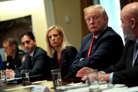President Donald Trump, flanked by Secretary of Homeland Security Kirstjen Nielsen (C), meets with members of Congress and U.S. law enforcement about crime and immigration issues, specifically the MS-13 gang, at the White House in Washington, D.C.
