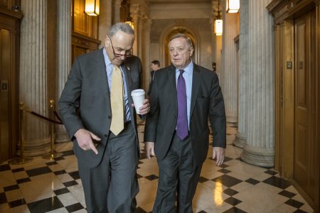 Senate Minority Leader Chuck Schumer, D-N.Y., left, and Sen. Dick Durbin, D-Ill., right, walk outside the chamber during debate in the Senate on immigration, at the Capitol in Washington, Wednesday, Feb. 14, 2018. Schumer said on the Senate floor that "the one person who seems most intent on not getting a deal is President Trump." (AP Photo/J. Scott Applewhite)