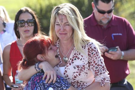 Parents wait for news after a reports of a shooting at Marjory Stoneman Douglas High School in Parkland, Fla., on February 14th, 2018, 2018. (AP Photo/Joel Auerbach)