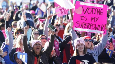 Attendees cheer a speaker during the Women's March "Power to the Polls" voter registration tour launch at Sam Boyd Stadium on January 21, 2018, in Las Vegas, Nevada.