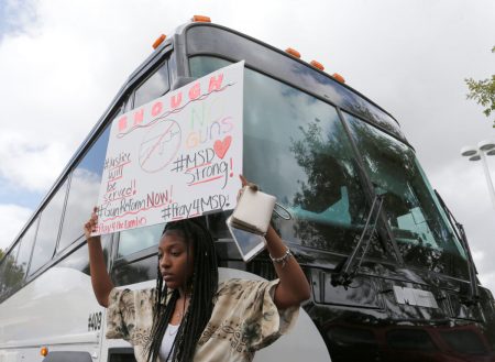 Tyra Hemans, 19, a senior at Marjory Stoneman Douglas High School, boards buses with fellow students to travel to Tallahassee, Florida to meet with legislators in Coral Springs, Florida.
