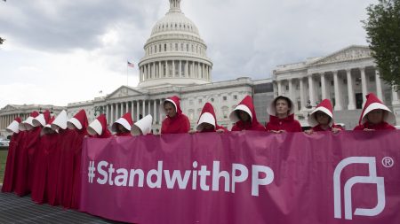Supporters of Planned Parenthood dressed as characters from The Handmaid's Tale protest last June outside the Capitol against Senate Republicans' health care bill.