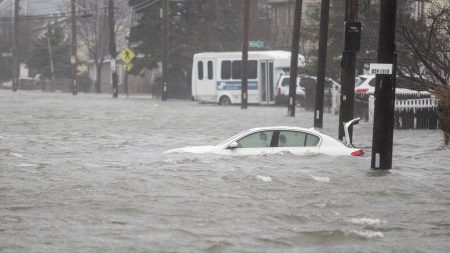 A flooded car sits in Hough's Neck on Friday in Quincy, Mass. A nor'easter hit the east coast on Friday, bringing coastal flooding, heavy snow and strong winds to the area.