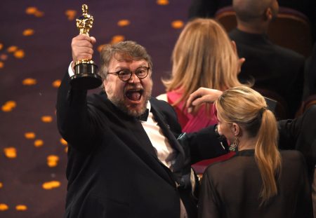 Guillermo del Toro, winner of the award for best director for "The Shape of Water" celebrates in the audience at the Oscars on Sunday, March 4, 2018, at the Dolby Theatre in Los Angeles.