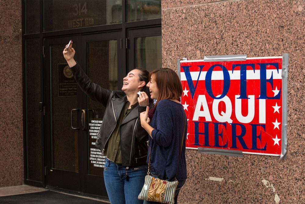 Voters take a selfie outside an early voting station in Austin on Feb. 23, 2018.

