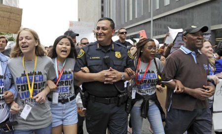 Houston Police Chief Art Acevedo, center, and Houston Mayor Sylvester Turner, far right, join demonstrators during a "March for Our Lives" protest for gun legislation and school safety Saturday, March 24, 2018 Photo: David J. Phillip, AP