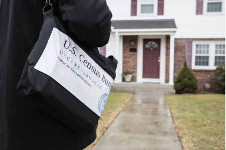 A U.S. Census worker conducts his 2020 survey in a neighborhood.