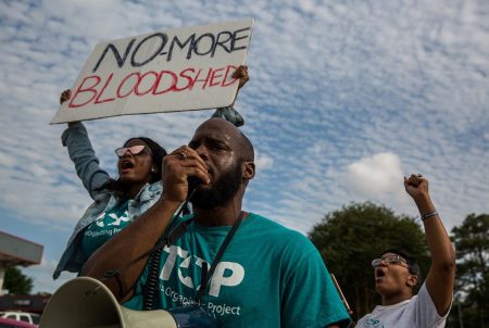 The Texas Organizing Project calls attention to a town hall meeting in north Houston at the intersection where Danny Ray Thomas, an unarmed black man, was shot by a Harris County Sheriff's deputy in March 2018.