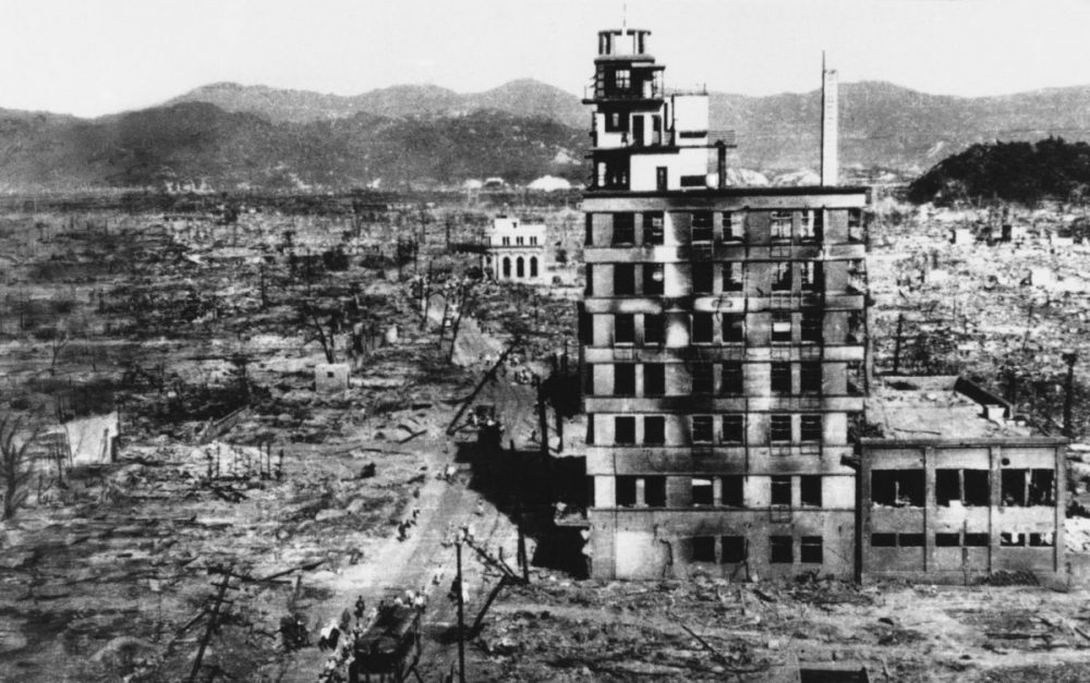 In this Aug. 8, 1945 file photo, survivors walk past one of the few buildings still standing two days after an atomic bomb was dropped on Hiroshima, Japan on August 6, 1945. The Los Alamos Historical Museum recently announced it won't be hosting a traveling exhibit organized by the Hiroshima Peace Memorial Museum and Nagasaki Atomic Bomb Museum until all parties can work out their differences over the theme. 