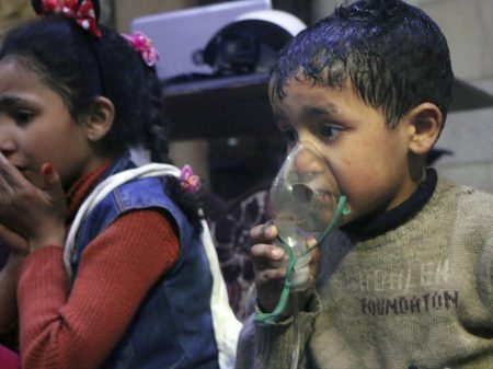 This image released early Sunday by the Syrian Civil Defense White Helmets shows a child receiving oxygen through respirators following an alleged poison gas attack in the rebel-held town of Douma, near Damascus, Syria.