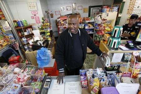 FILE - In this Feb. 26, 2018, file photo, Carl Lewis in his market in Rankin, Pa. About half of Lewis' customers pay with benefits from the federal Supplemental Nutrition Assistance Program, so the government's proposal to replace the debit card-type program with a pre-assembled box of shelf-stable goods delivered to recipients worries him and other grocery operators in poor areas. Food stamp administrators across the country are expressing reservations about "America's Harvest Box," pitched by Agriculture Department officials as a way to cut costs and improve efficiency. The government is proposing to replace the debit card-type program with a pre-assembled box of shelf-stable goods delivered to recipients. (AP Photo/Gene J. Puskar, File)