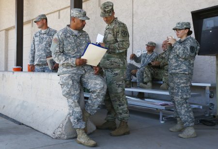 Arizona National Guard soldiers receive their reporting paperwork prior to deployment to the Mexico border at the Papago Park Military Reservation, Monday, April 9, 2018, in Phoenix. (AP Photo/Ross D. Franklin)