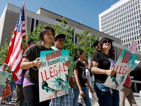 FILE - In this June 15, 2010, file photo, immigration reform advocates march around the Federal Courthouse in downtown Denver. The federal government is putting on hold an orientation program that helps tens of thousands of immigrants navigate the country's complex immigration court system. (AP Photo/David Zalubowski, File)