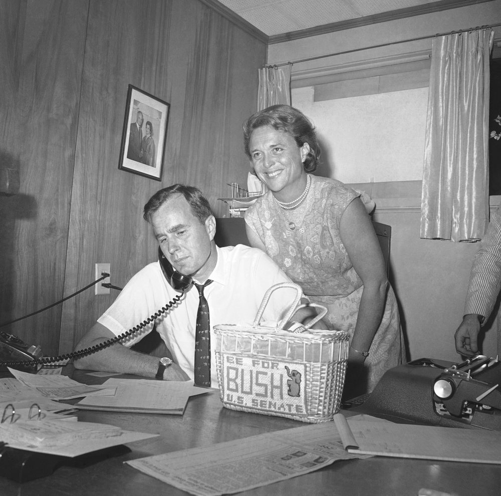 George Bush, candidate for the Republican nomination for the U.S. Senate, gets returns by phone at his headquarters in Houston, Saturday, June 6, 1964 as his wife Barbara, beams her pleasure at the news. Bush was leading his opponent Jack Cox in the run-off primary. Bush will face Sen. Ralph Yarborough (D-Tex) in the November general election if his lead holds and he is the winner. (AP Photo/Ed Kolenovsky)