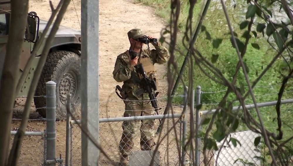 FILE - In this April 10, 2018, file frame from video, a National Guard troop watches over Rio Grande River on the border in Roma, Texas. The deployment of National Guard members to the U.S.-Mexico border at President Donald Trump's request was underway with a gradual ramp-up of troops under orders to help curb illegal immigration. (AP Photo/John Mone, File)