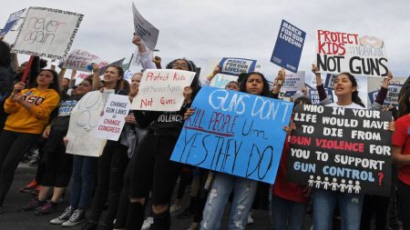 Demonstrators march toward Las Vegas City Hall during the March for Our Lives rally last month in Las Vegas, where 58 people were killed in an October 2017 mass shooting.