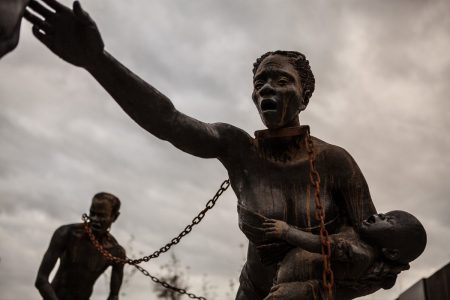 A statue of a chained man is on display at the National Memorial for Peace and Justice, a new memorial to honor thousands of people killed in racist lynchings, Sunday, April 22, 2018, in Montgomery, Ala.