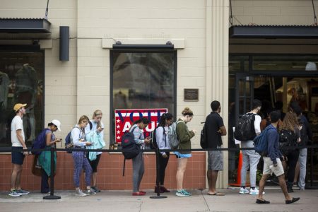 Voters line up outside of The University Co-op across from the University of Texas at Austin.