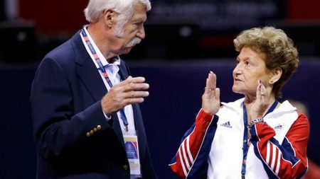 In this June 29, 2012, file photo, Bela Karolyi, left, and his wife Martha Karolyi talk on the arena floor before the start of the preliminary round of the women's Olympic gymnastics trials in San Jose, Calif.