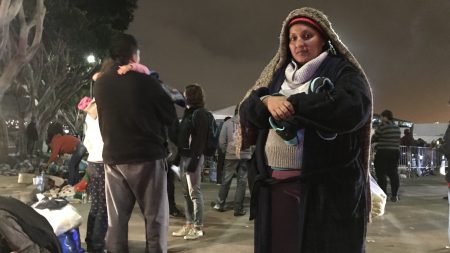 Deana Quczada of Honduras has been camping with her young children on the street in Tijuana for several days. Going back to the violence in her home country is not an option, she says.