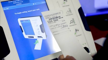 This Oct. 19, 2017, file photo shows a new voting machine which prints a paper record on display at a polling site in Conyers, Ga. Georgia officials have estimated it could cost over $100 million to adopt the machines statewide.