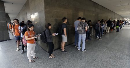 In this March 6, 2018, file photo, a line of mostly students wait to vote at a Texas primary election polling site on the University of Texas campus in Austin, Texas. Texas holds its primary runoff election Tuesday, May 22, 2018, just four days after a trench coat-clad student killed at least 10 people and wounded others at his Santa Fe High School near Houston. But it's unlikely to be a major factor in Tuesday's balloting, which will decide 34 races, including for governor and Congress, where no candidate won at least 50 percent of the votes cast during Texas' March 6 primary.