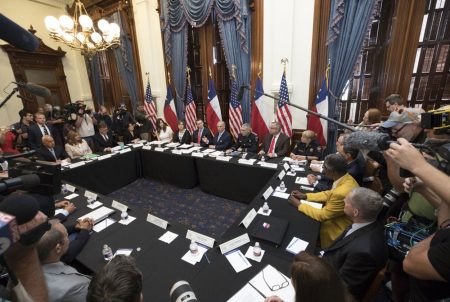 Gov. Greg Abbott (top center, in front of U.S. flag) held the first of three roundtable discussions on school safety in the aftermath of the Santa Fe high School shooting, in Austin on May 22, 2018.