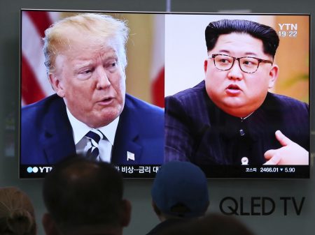 People watch a TV screen showing file footage of U.S. President Donald Trump, left, and North Korean leader Kim Jong Un during a news program at the Seoul Railway Station in Seoul, South Korea on May 24.