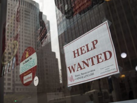 A "help wanted" sign hangs on a window of a restaurant in New York City. The U.S. economy gained a stronger-than-expected 223,000 jobs last month and the unemployment rate edged down to an 18-year low