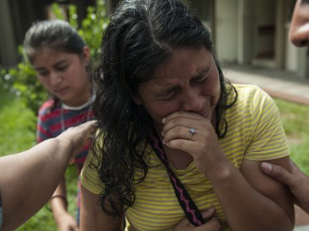 Lilian Hernandez cries as she is comforted by her husband at the Mormon church that has been enabled as a shelter near Escuintla, Guatemala, on Tuesday. Hernandez lost 36 family members in all, missing and presumed dead in the town of San Miguel Los Lotes after the fiery volcanic eruption of the Volcan de Fuego, or Volcano of Fire, in south-central Guatemala.