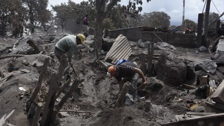 Residents search for victims of the Fuego volcano eruption in the ash-covered village of San Miguel Los Lotes, in Escuintla, about 20 miles southwest of Guatemala City, on Thursday.