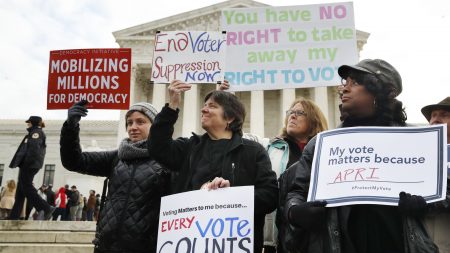 People rally outside of the Supreme Court in opposition to Ohio's voter roll purges in January. The court upheld the controversial law Monday.