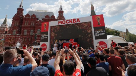 People watch as the FIFA World Cup trophy is displayed in central Moscow. Russia is hosting soccer's mega-event for the next month — and people around the world will be watching matches live, online and on TV.