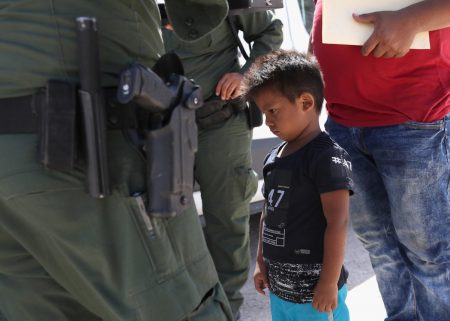 A boy and father from Honduras are taken into custody by U.S. Border Patrol agents near the U.S.-Mexico Border on June 12, 2018 near Mission, Texas. President Donald Trump signed an executive order Wednesday ending family separation at the border.