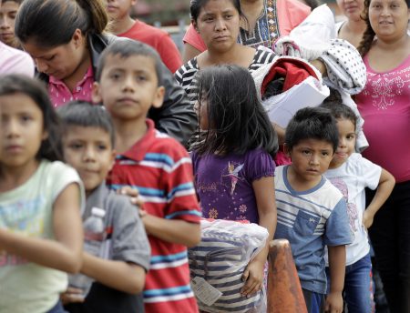 Immigrant families line up to enter the central bus station after they were processed and released by U.S. Customs and Border Protection, Sunday, June 24, 2018, in McAllen, Texas. (AP Photo/David J. Phillip)