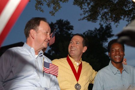 Left to right: John Lawrence, Attorney Mitchell Katine and Tyron Garner celebrate the recent landmark Supreme Court ruling on a Texas sodomy law, during a gay pride parade in Houston on June 28, 2003.