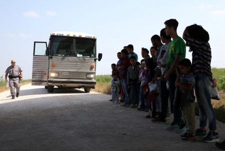 Immigrants who turned themselves in to border patrol agents after illegally crossing the border from Mexico into the U.S. wait to be transported for processing in the Rio Grande Valley sector, near McAllen, Texas, on April 2, 2018.