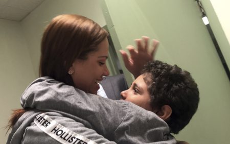 In this Tuesday, June 26, 2018 photo provided by paralegal Luana Mazon, Lidia Karine Souza, 27, hugs her 9-year-old son Diogo De Olivera Filho as Souza visited her son for the first time since they were separated at the U.S.-Mexico border in late May. Her son remained in custody, much of it quarantined in a room because he had the chicken pox, and she has been told the soonest the boy could be released is late July. She filed a lawsuit against the Trump administration. An emergency hearing is scheduled for Thursday. (Courtesy of Luana Mazon via AP)