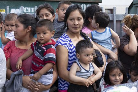 About 25 immigrant mothers and their children caught coming across the Texas-Mexico border are released at the McAllen bus station wearing ankle monitors on June 22, 2018.