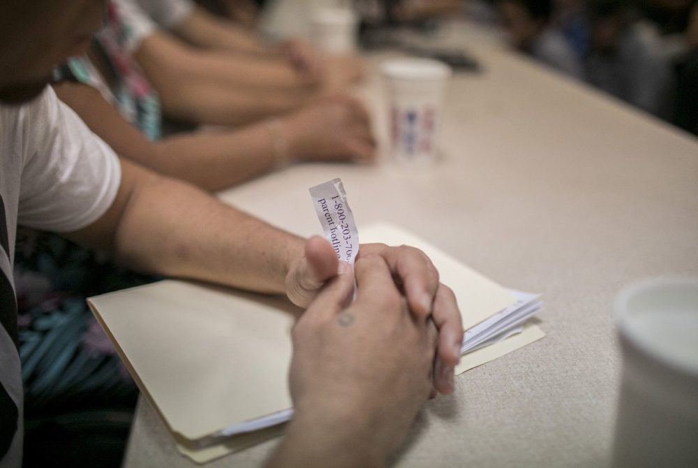 Mario, who did not want to release his last name, holds the number to the hotline parents are suppose to call to try to find their children during a press conference at the Casa Vides Annunciation House immigrant shelter on Monday, June 25, 2018, in El Paso.  