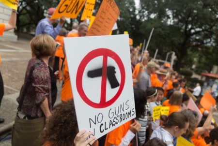 University of Texas at Austin faculty and students protest a law allowing people with concealed handgun licenses to enter campus buildings with their firearms. A lawsuit challenging the policy is headed to federal appeals court on Wednesday.