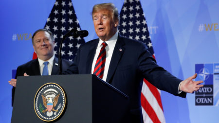 President Trump said Thursday that he has succeeded in getting U.S. allies to pledge more money for the alliance. Secretary of State Mike Pompeo looked on at a news conference after the NATO summit in Brussels.